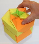 Recycled flyer box, type 2.  Note that it is being held up in the air by the design on the lid.