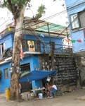 Amazing power distribution practice in a poor area.  These meters are open to the weather.