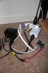 The hackery it takes to make an Insteon appliance control module not burn itself out.  It has a relay to control appliances, but it has a load sensor circuit.  The damn thing leaks enough current to trigger the fluroescent ballast and fry the load circuit which fails "closed".  ie: permanently on.

What is here is a 12V transformer plugged into the relay ApplianceLincV2 outlet.  The 12V output triggers an external relay.  The external relay provides power to the light, but with no load sensing circuit to fail.