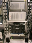 Bottom up: tape drive, bento, ncvsup (was cvsup-master), vmtest (now cerberus), backup, and axp's.  Hidden behind the tape cartridges (above backup, below shelf) is ftp-master.