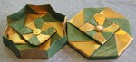 OCTAGONAL GIFT BOX S02

LID: 8 pieces of 10 inch square wallpaper
BASE: 8 pieces of 9 7/8 inch square wallpaper.
Paper is painted gold on the back. Center buttons secured with button safety pins.

VIEW: Different view of  inside of base and outside (top) of lid.